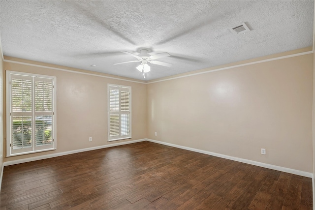 spare room featuring ceiling fan, ornamental molding, a wealth of natural light, and dark hardwood / wood-style flooring