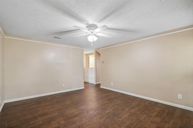 empty room featuring ceiling fan, ornamental molding, a textured ceiling, and dark hardwood / wood-style flooring