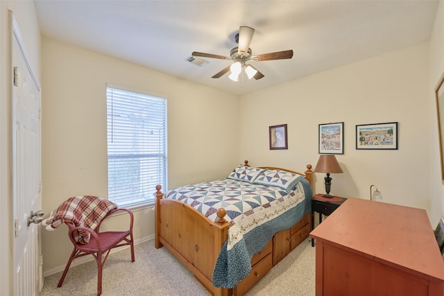 bedroom featuring ceiling fan and light carpet