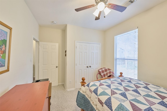 bedroom featuring light carpet, a closet, and ceiling fan