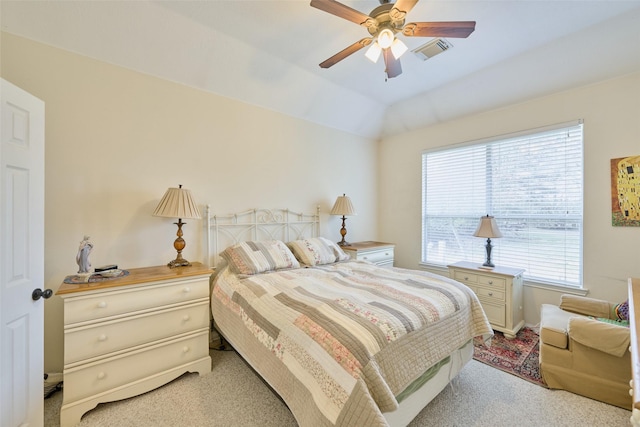 bedroom with ceiling fan, vaulted ceiling, and light carpet