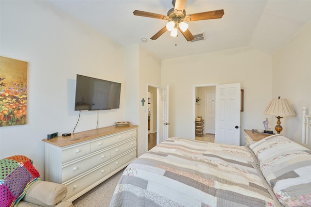 bedroom with ceiling fan, vaulted ceiling, and light colored carpet