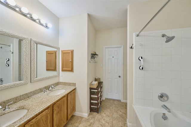 bathroom with tile patterned floors, vanity, and tiled shower / bath combo