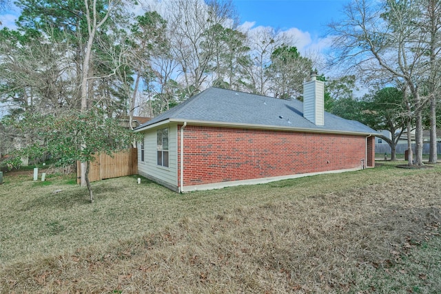 view of side of home featuring a yard