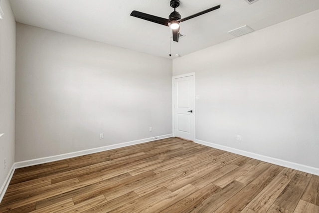 empty room with hardwood / wood-style flooring and ceiling fan