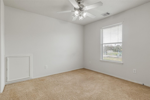 unfurnished room featuring ceiling fan and light carpet