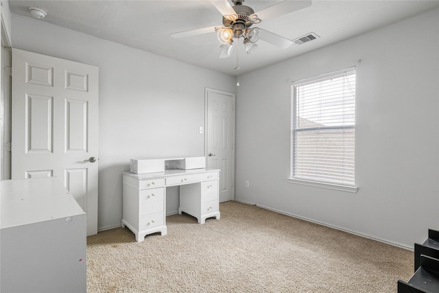 carpeted office featuring ceiling fan