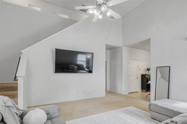 living room featuring high vaulted ceiling, light colored carpet, and ceiling fan