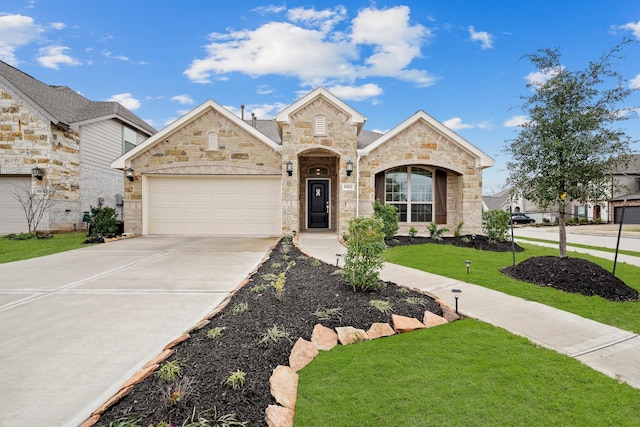 view of front of property with a garage and a front lawn