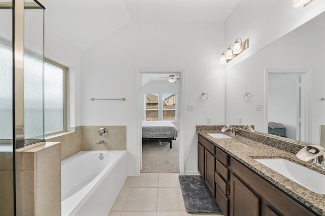 bathroom featuring lofted ceiling, vanity, ceiling fan, a bath, and tile patterned floors