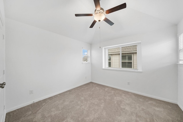 carpeted spare room with ceiling fan and lofted ceiling