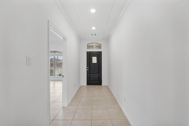 entryway featuring light tile patterned floors and ornamental molding