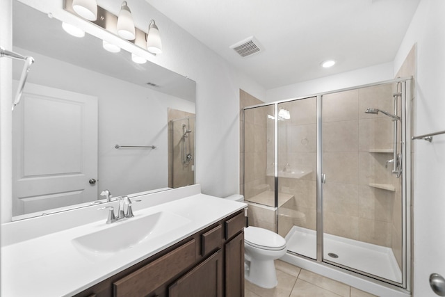 bathroom with tile patterned floors, toilet, a shower with shower door, and vanity