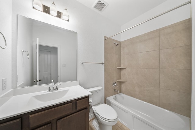 full bathroom with tiled shower / bath, vanity, and toilet