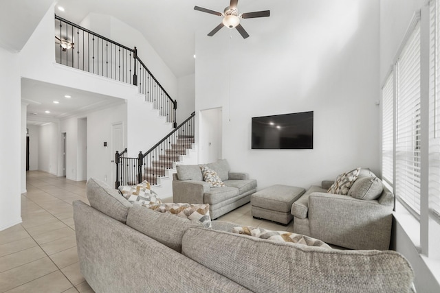 tiled living room with a high ceiling and ceiling fan