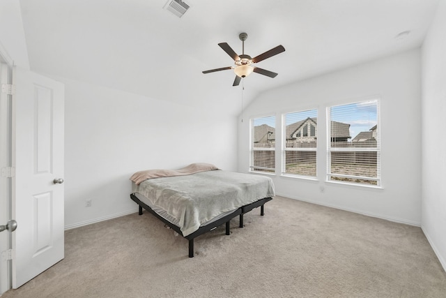 carpeted bedroom with vaulted ceiling and ceiling fan