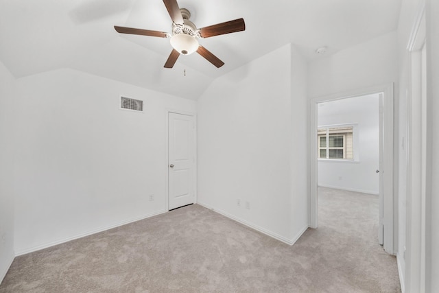 unfurnished room with lofted ceiling and light carpet