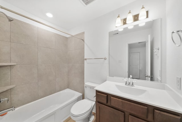 full bathroom featuring vanity, toilet, and tiled shower / bath combo