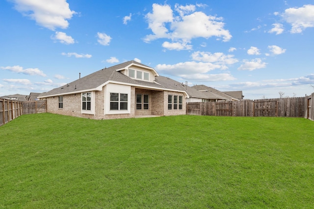 back of house featuring a yard