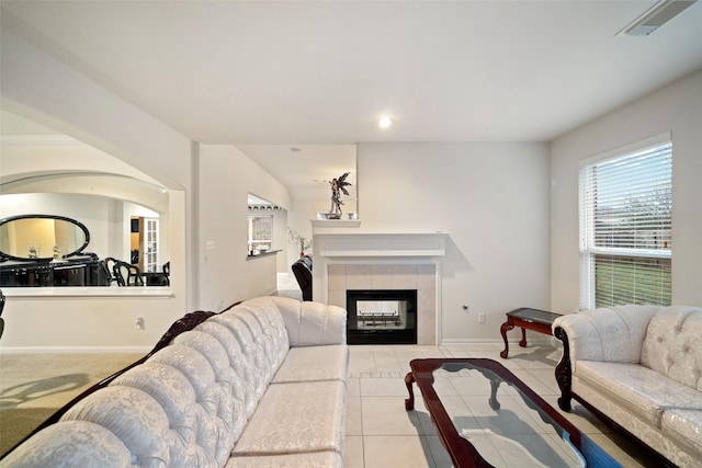 tiled living room with a tiled fireplace