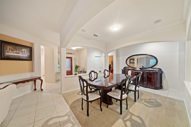 dining room with ornamental molding and light tile patterned floors