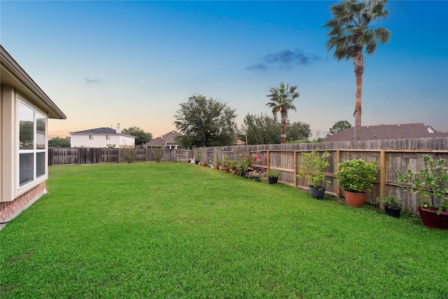 view of yard at dusk