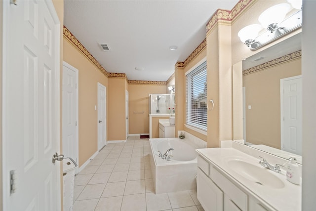 bathroom featuring independent shower and bath, vanity, and tile patterned floors