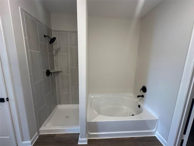 bathroom featuring independent shower and bath and hardwood / wood-style floors