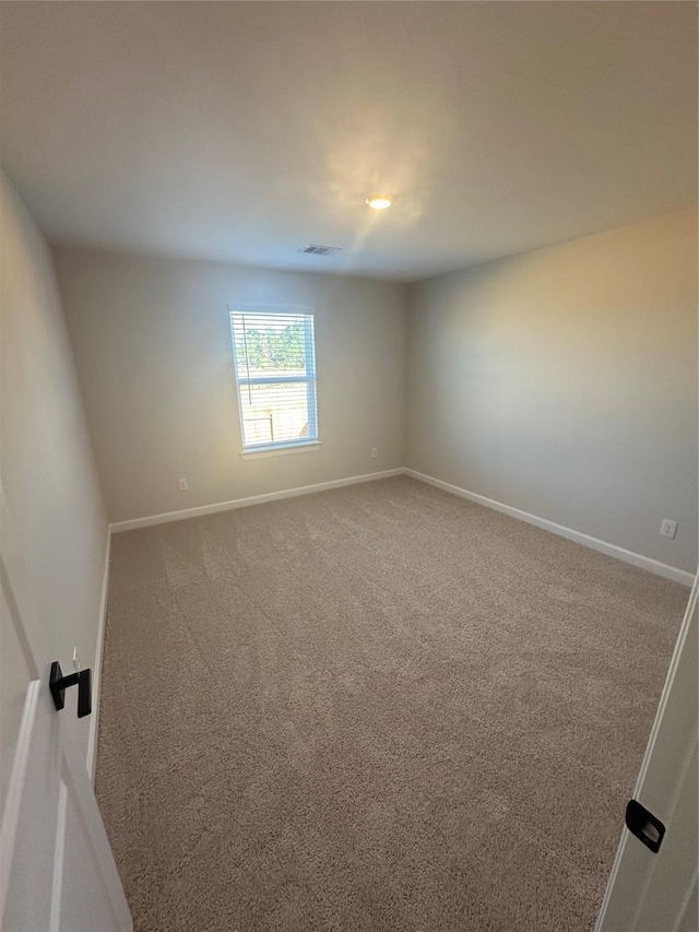 spare room featuring carpet floors