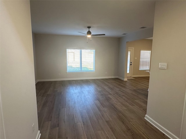 unfurnished room with ceiling fan and dark hardwood / wood-style flooring