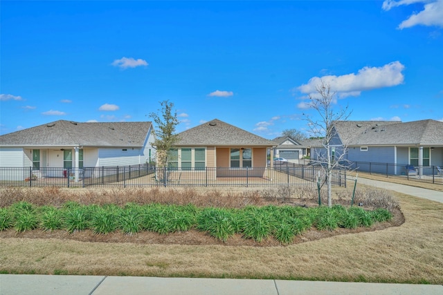 view of front of house featuring a fenced front yard and concrete driveway