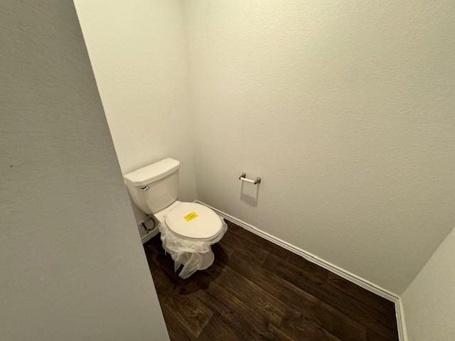 bathroom featuring hardwood / wood-style flooring and toilet