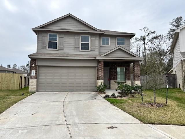 front of property with a garage and a front lawn