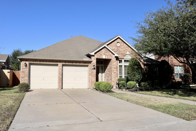 view of front of property featuring a garage and a front yard