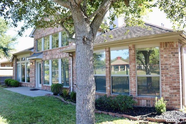 rear view of house with a lawn