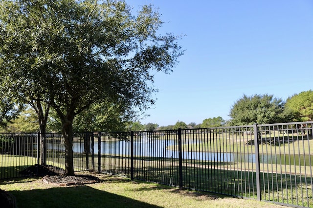 exterior space with a lawn and a water view