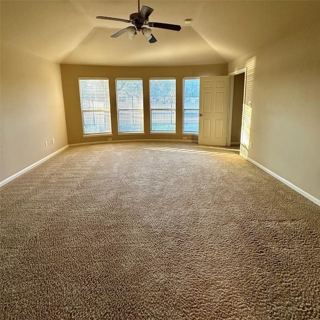 carpeted empty room with ceiling fan and lofted ceiling