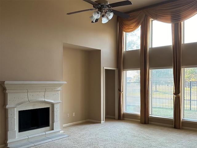 unfurnished living room with plenty of natural light, a premium fireplace, and light carpet