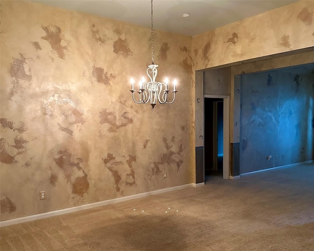 unfurnished room featuring carpet flooring and a notable chandelier