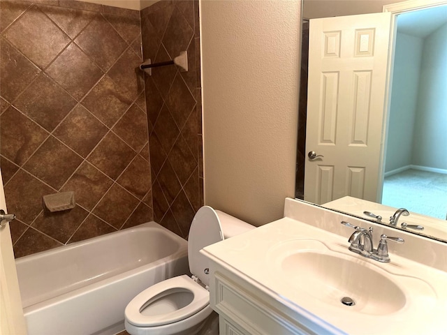 full bathroom with tiled shower / bath, vanity, and toilet