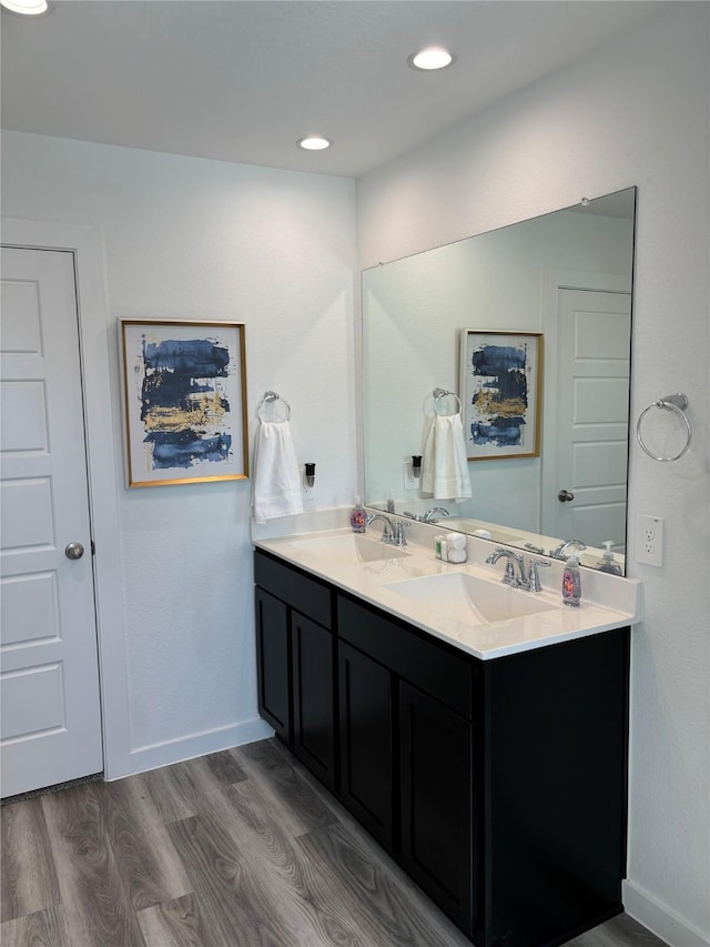 bathroom featuring hardwood / wood-style flooring and vanity