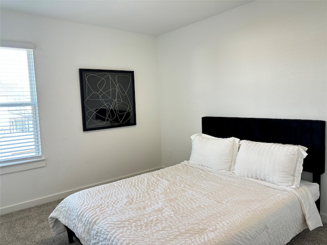 carpeted bedroom featuring multiple windows