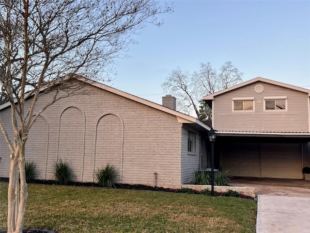 view of home's exterior featuring a garage and a yard