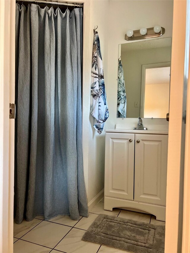 bathroom featuring vanity, tile patterned floors, and walk in shower