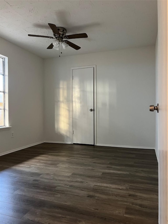 unfurnished room featuring ceiling fan and dark hardwood / wood-style flooring