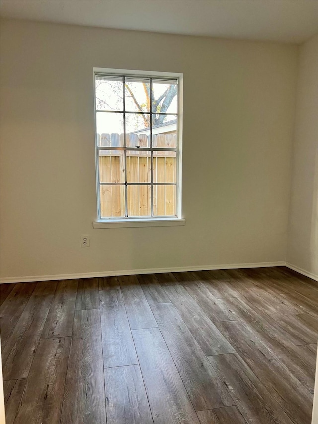 spare room with dark wood-type flooring