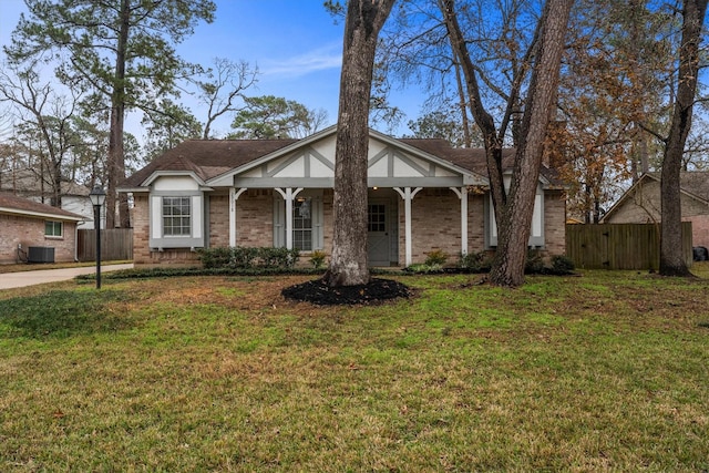 view of front of home with central AC and a front lawn