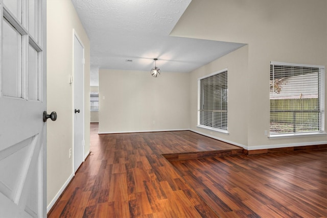 interior space with dark hardwood / wood-style floors and a textured ceiling