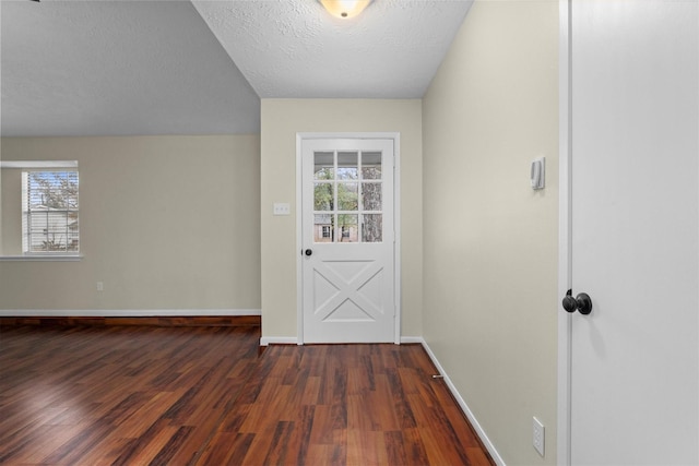 doorway featuring dark hardwood / wood-style floors and a textured ceiling