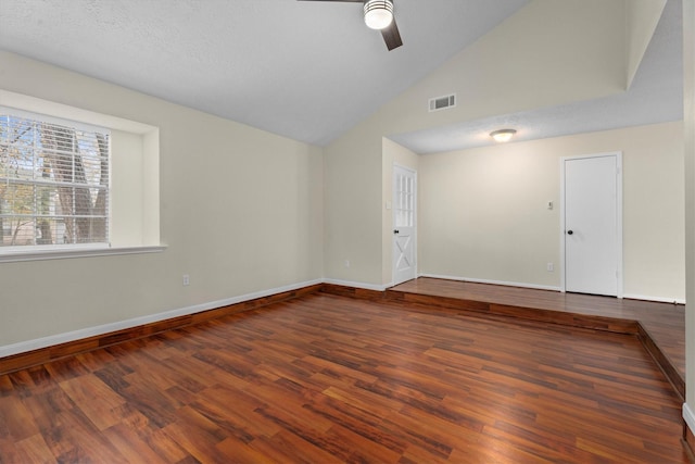 spare room with dark wood-type flooring, ceiling fan, and vaulted ceiling